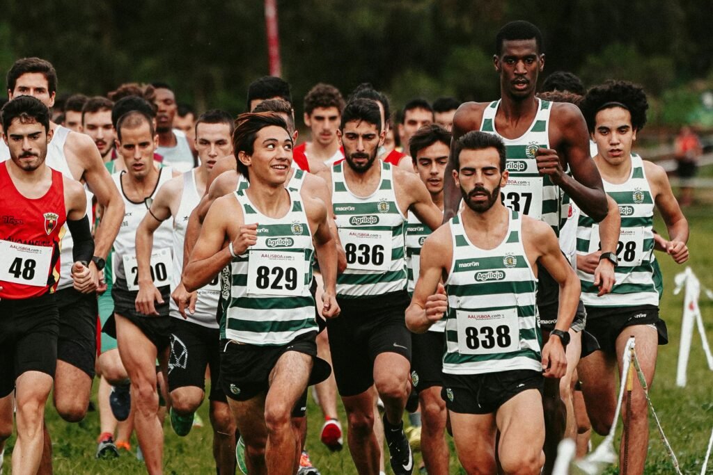 A dynamic shot of diverse men competing in an outdoor marathon race on grass.
